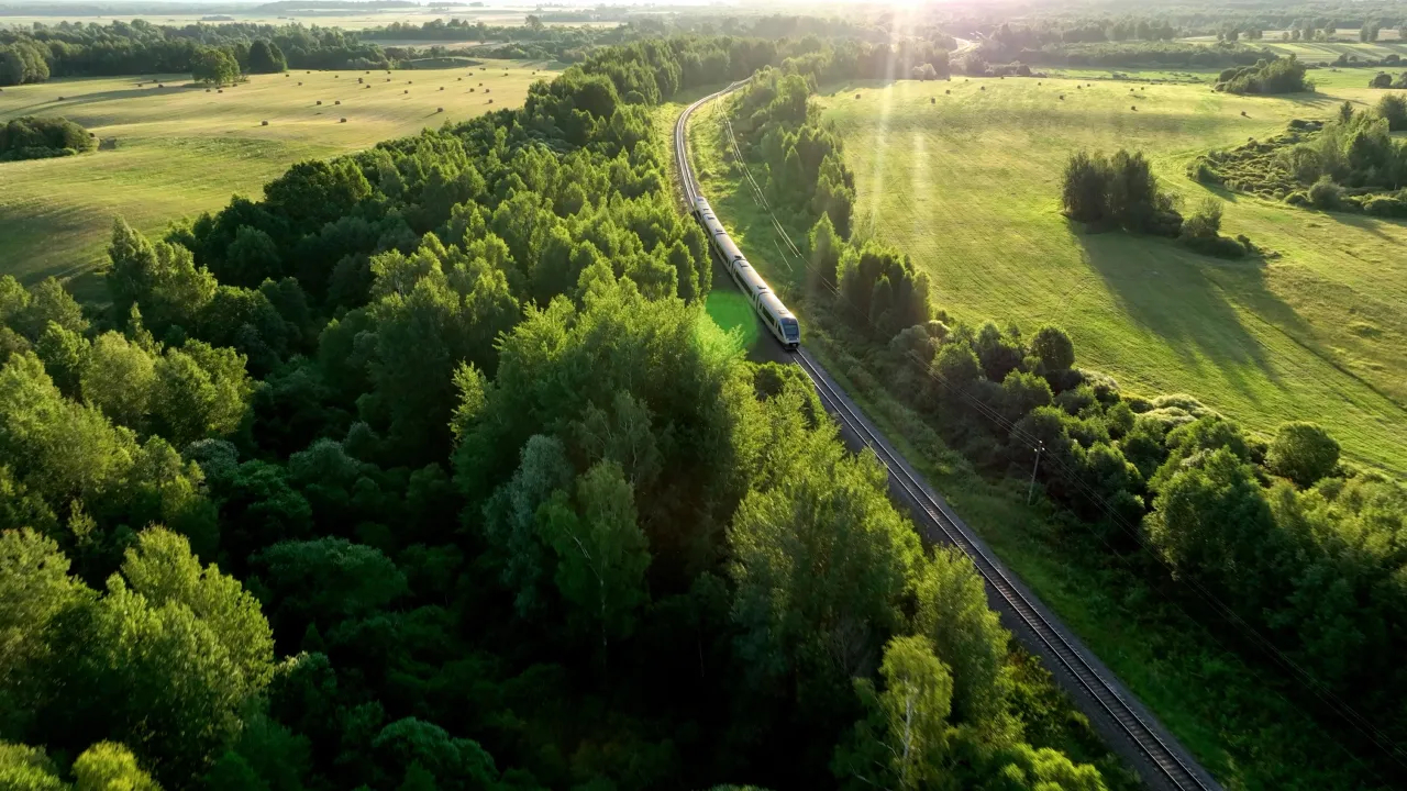 Passenger train travelling through green countryside